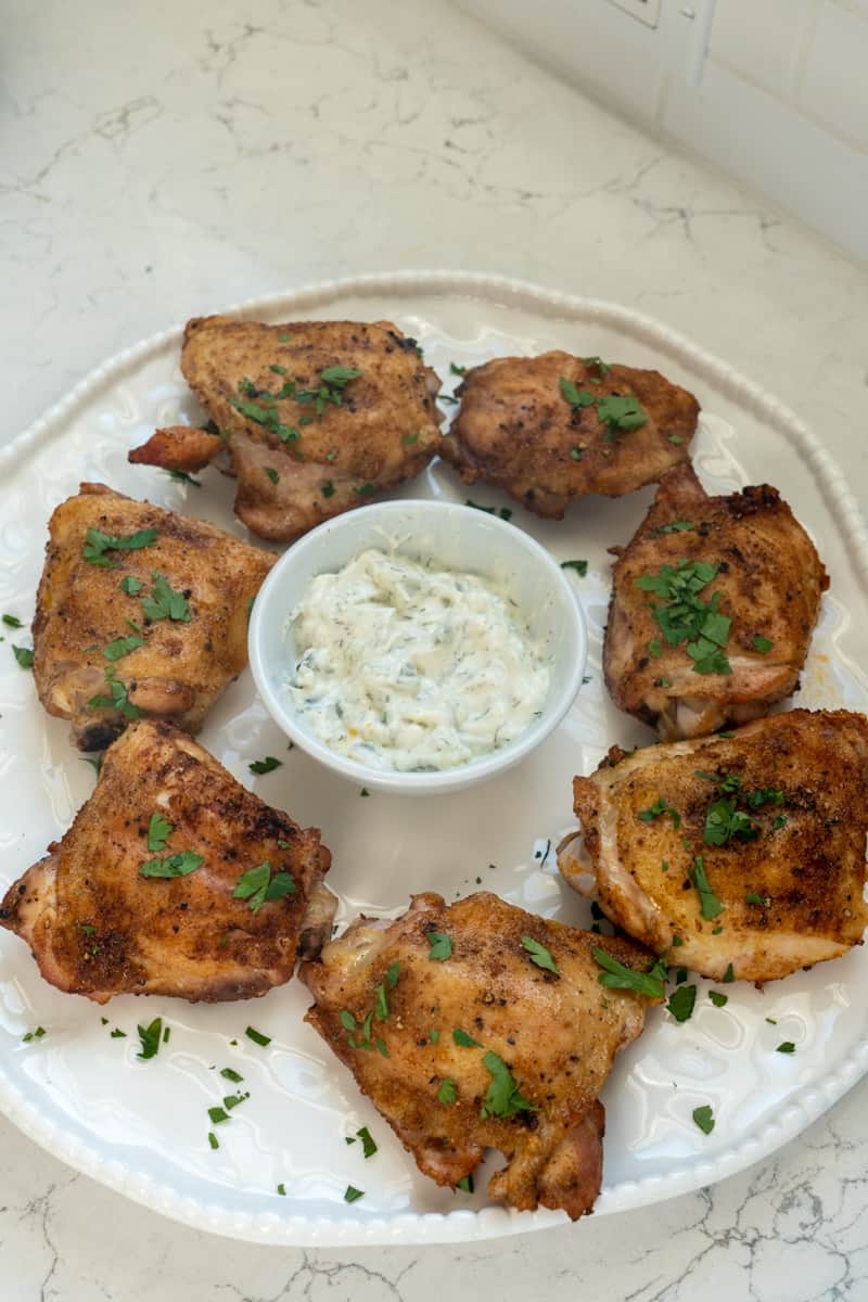 This Paprika Parmesan Chicken (Air Fryer and Oven) is made with chicken thighs, olive oil, paprika, garlic powder, parsley, baked and topped with parmesan cheese or tzatziki. 