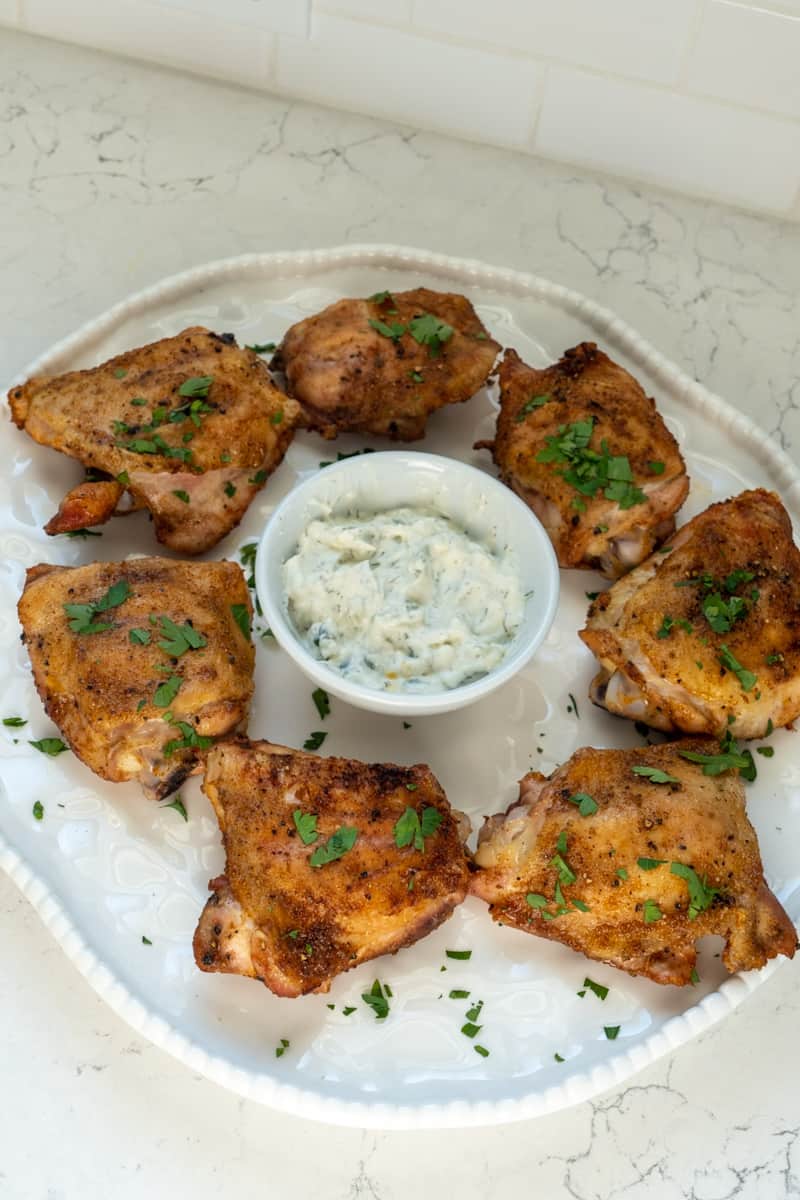 Take the chicken out and garnish with parsley. Serve with tzatziki on the side or parmesan cheese on top. Enjoy this aked Paprika Chicken Thighs Recipe. 
