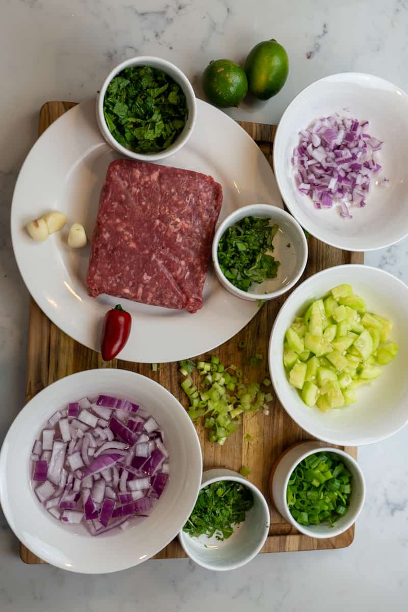 This Thai Lamb Larb Recipe is made by cooking ground lamb and tossing into a bowl of cucumber, scallions, cilantro, mint, and Thai basil.