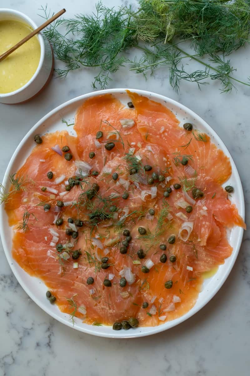 This Salmon Carpaccio with Capers and Shallots is made with fresh salmon, lemon, shallots, dill, capers and a homemade mustard dressing.