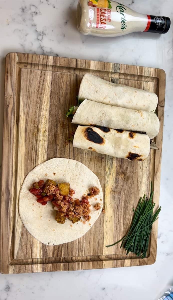 Fill each wrap with the baked tofu, top with the pico de gallo, lettuce, quinoa, and dressing.