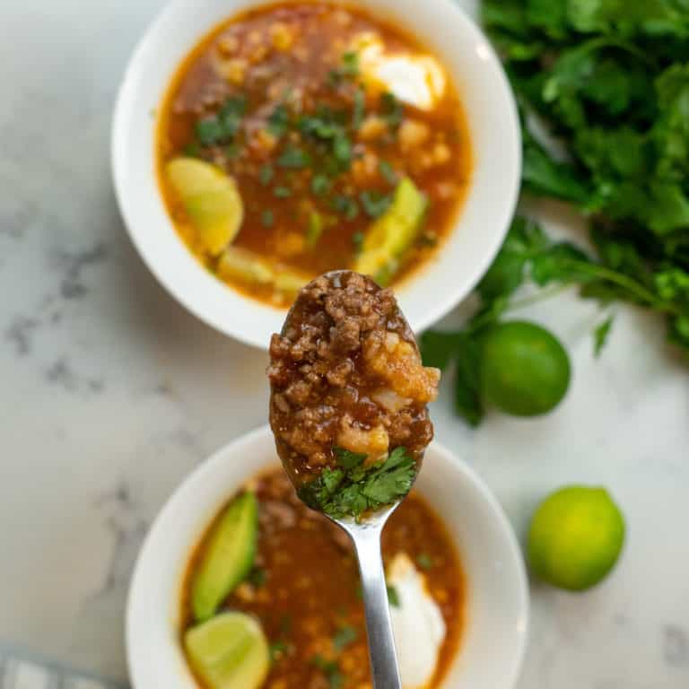 This picadillo soup recipe is made with onion, garlic, jalapeno, tomatoes, spices, ground beef, broth, limes, cilantro and simmered to perfection.