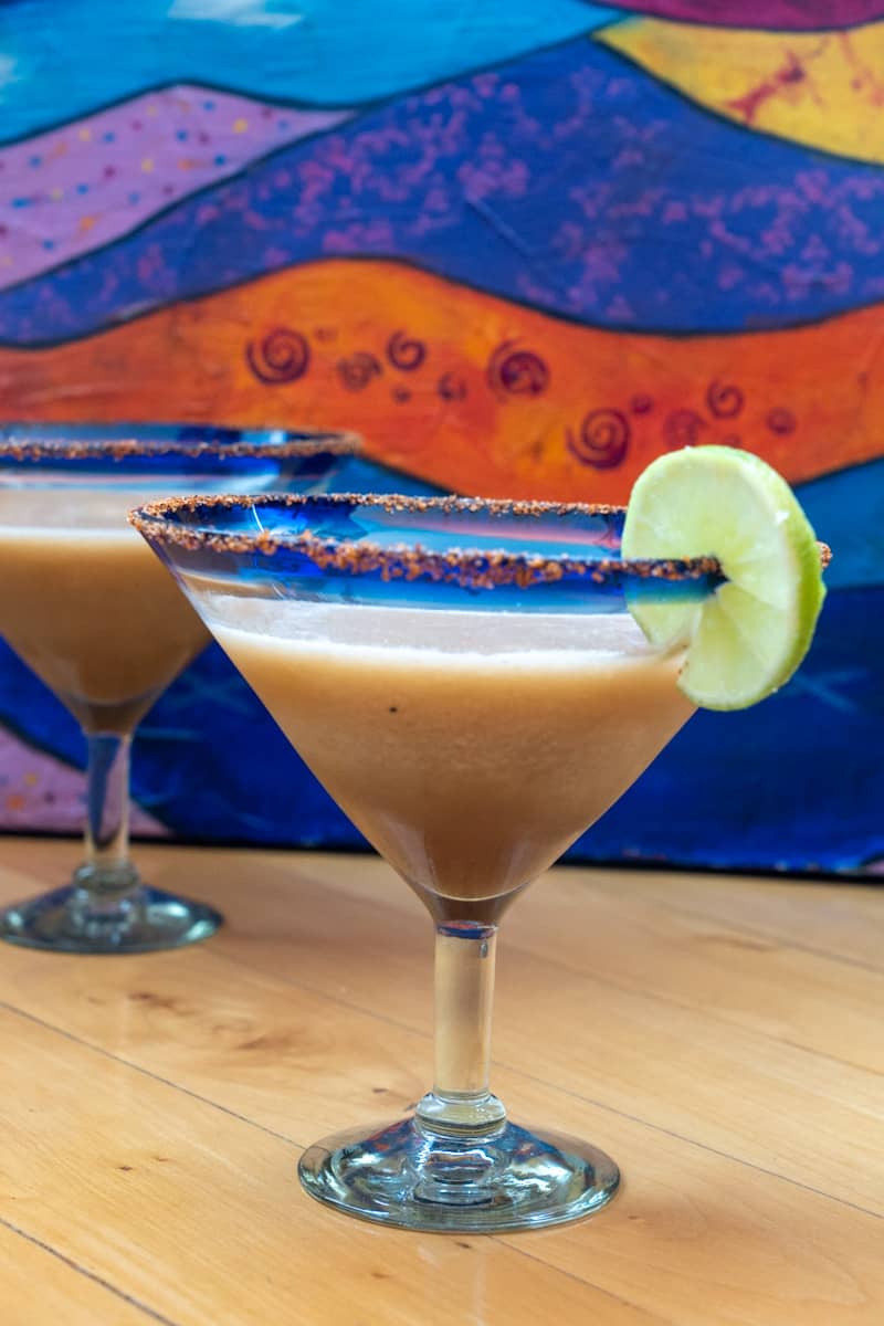 This Tamarind Margarita is made with Tamarind syrup, tequila, lime juice, ice, Tajin, and blended to perfection.
