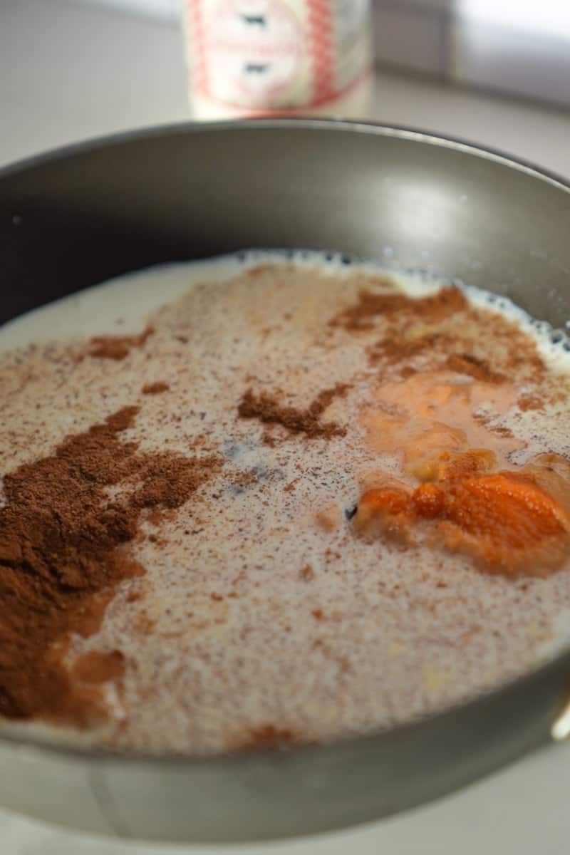 Combine milk, pumpkin, maple syrup, cinnamon, nutmeg, ginger and cloves in a small saucepan over medium low heat. 