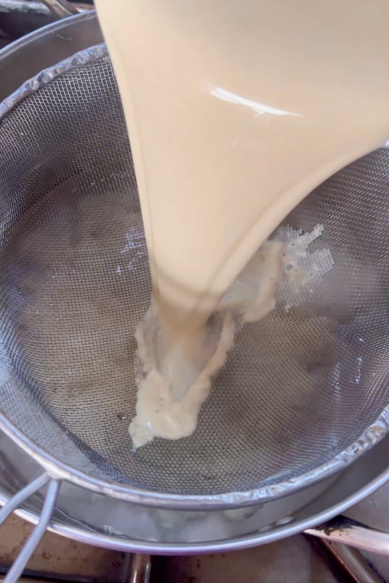 When the water starts boiling, put a strainer above pot and pour the flour mixture through the bowl  into the pot of boiling water. 