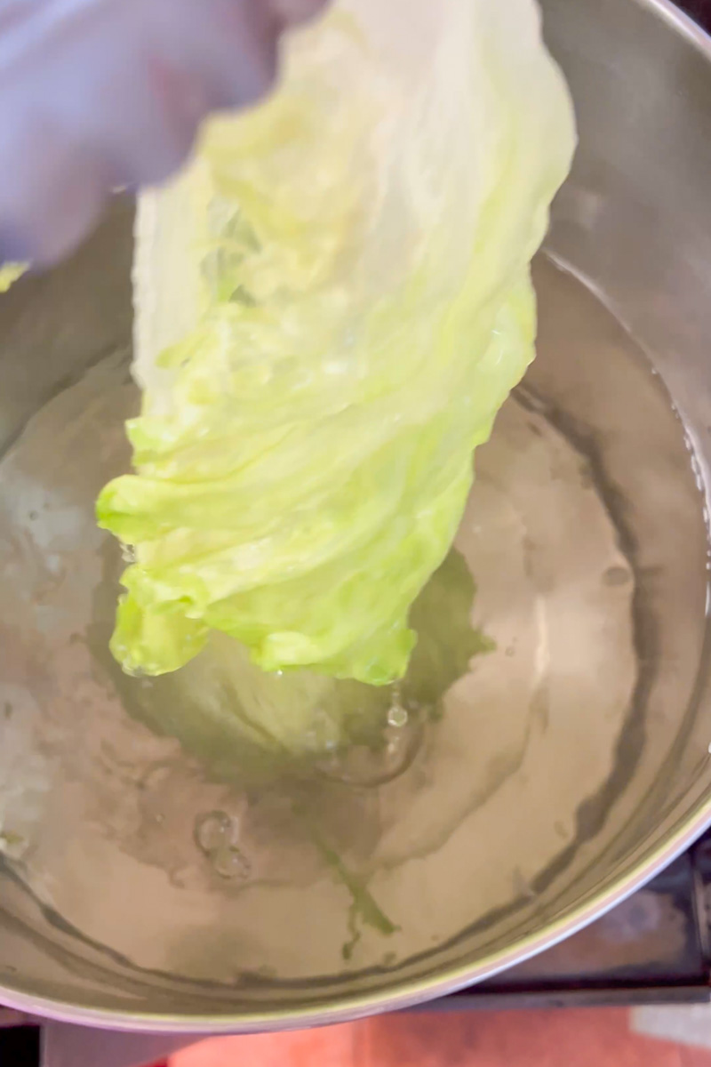 Bring water to a boil. Salt the water generously. Add the lettuce until the lettuce becomes bendy. Use tongs to slowly keep pulling out the leaves and they come off easily from the stem. Add them in a strainer. It should take about 4-6 minutes. 