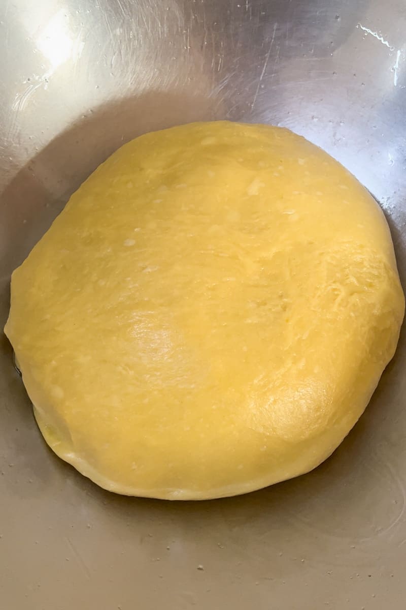Let the dough rise: Place the dough back into the bowl and cover in cling wrap. Let it rise until doubled in size. Make sure to place someplace warm in your house so it can rise quickly.