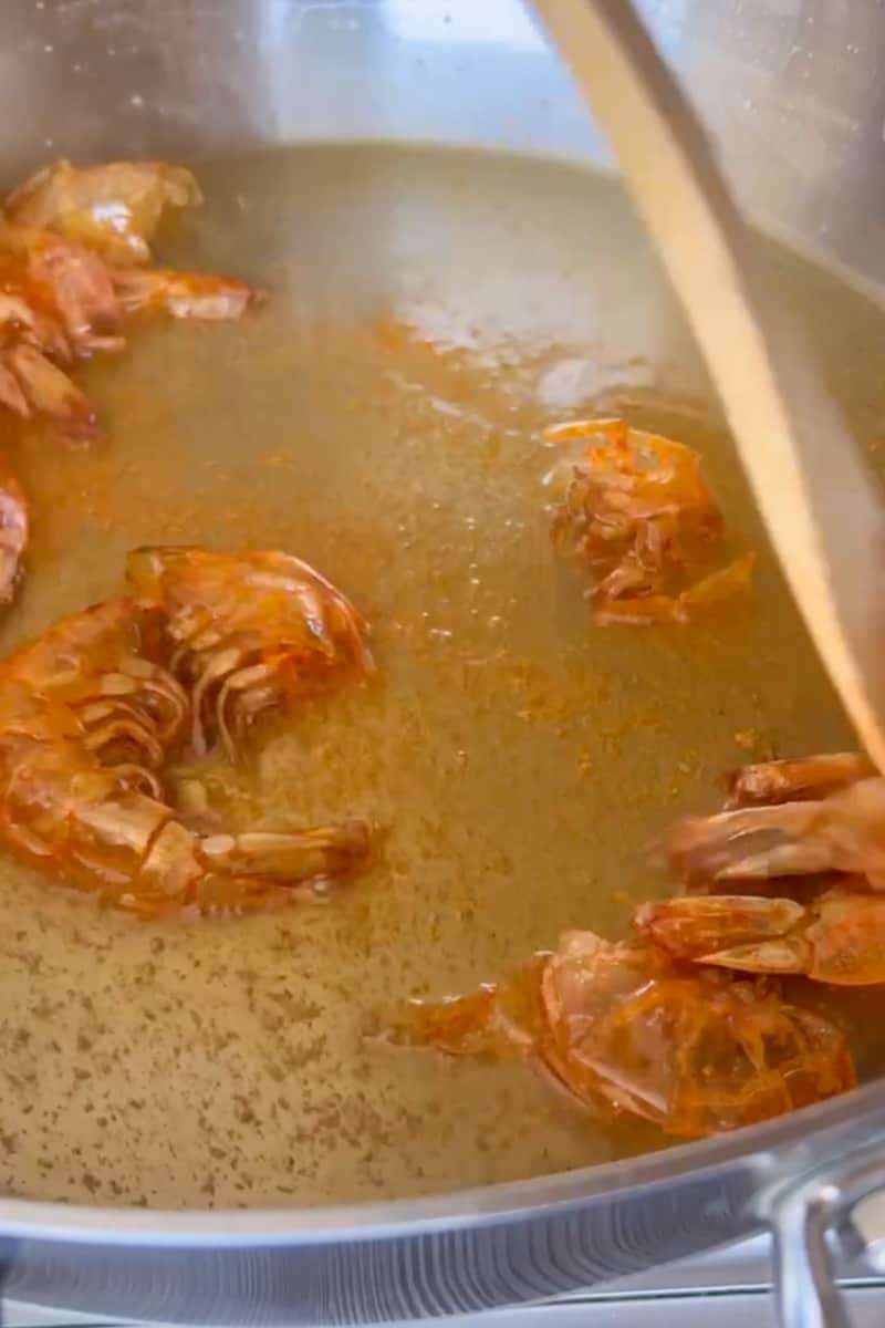 Add oil in the pan and on low heat, warm up the oil. Add the achiote and mix. Turn off heat and let the mixture rest for 20 minutes, until the oil turns red. Remove the shells from the shrimp and reserve for later. Add the shrimp shells in the oil until they change colors. With a slotted spoon remove the shells. 