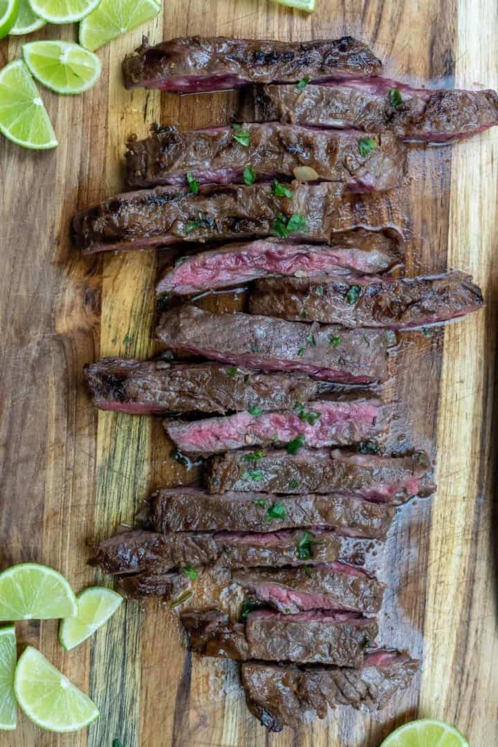 This Carne Asada Recipe is made with skirt steak, olive oil, soy sauce, apple cider vinegar, jalapeños, onion, and limes.