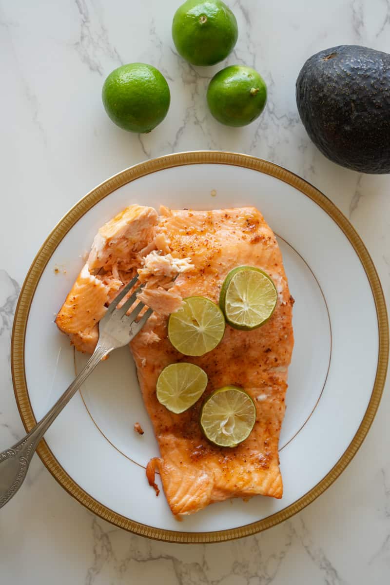 This Spicy Baked Salmon Recipe is made with fresh salmon, Tajin, honey, garlic powder and baked to perfection. 