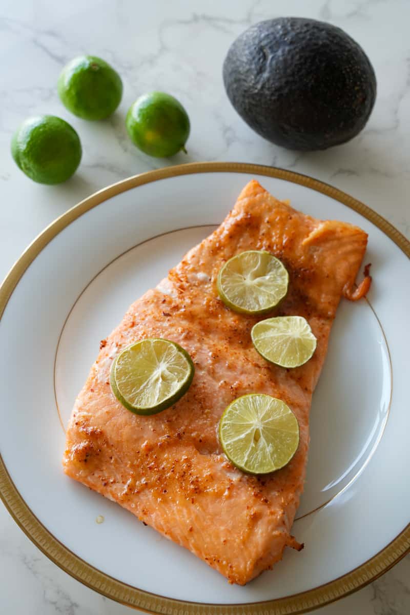 This Spicy Baked Salmon Recipe is made with fresh salmon, Tajin, honey, garlic powder and baked to perfection. 