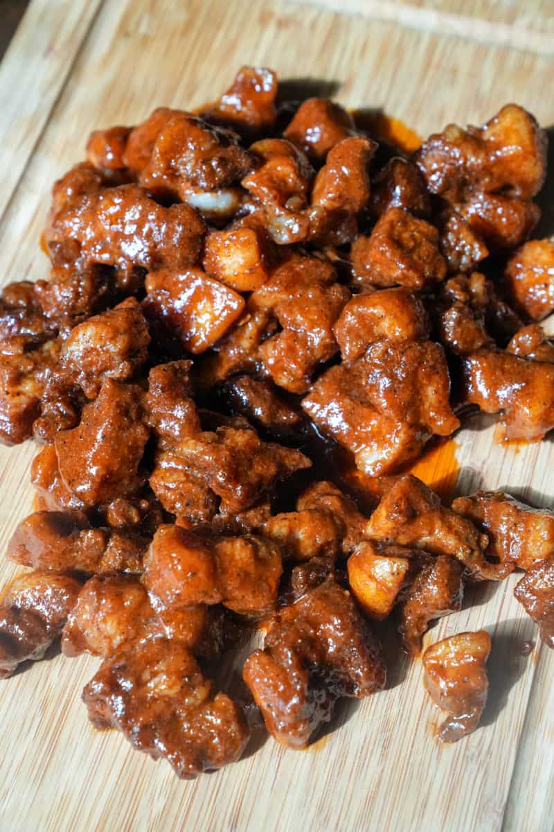 Coating the Burnt Ends: Once the pork belly cubes are tender and have a nice smoky color, transfer them to a mixing bowl. Pour the sauce over the burnt ends and gently toss to coat each cube with the sauce. Enjoy this Pork Belly Burnt Ends Recipe.