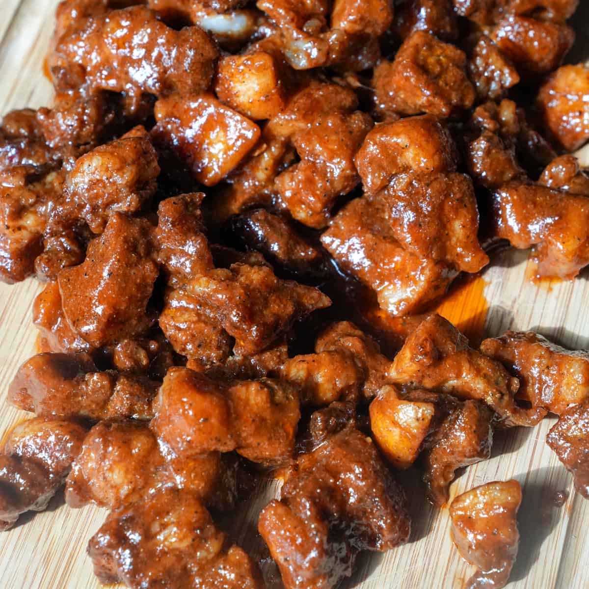 Experience barbecue bliss with our Pork Belly Burnt Ends: juicy cubes of pork belly, smoked to perfection until caramelized and tender, bursting with flavor in every bite.