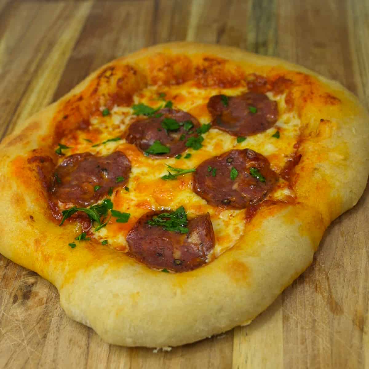 Experience the essence of Italy with our Neapolitan Pizza Recipe: thin, crispy crust topped with tangy tomato sauce, creamy mozzarella, and fresh basil leaves.