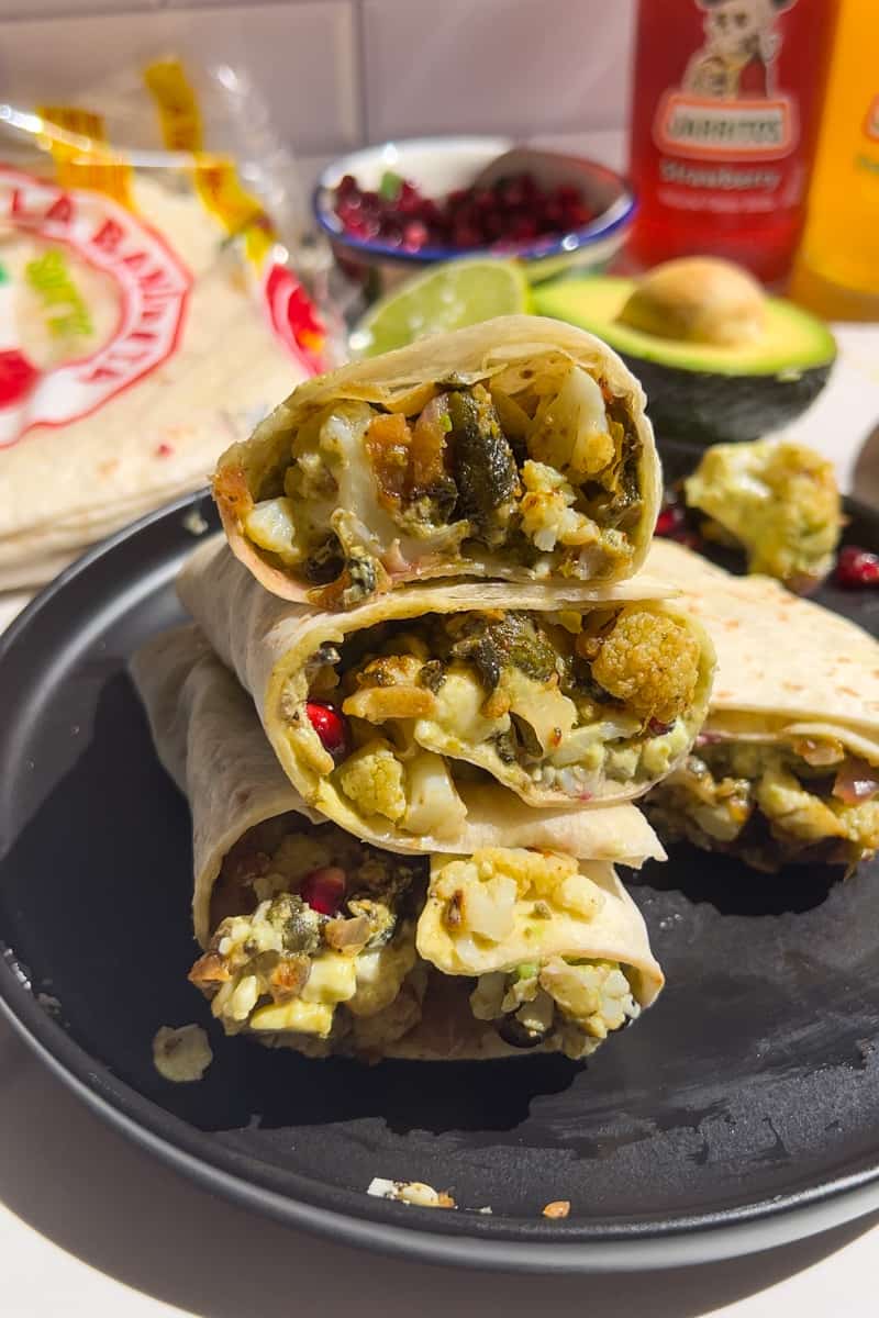 This Poblano Cauliflower Tacos Recipe is made with roasted cauliflower and poblanos, topped with a green salsa and pomegranate seeds.
