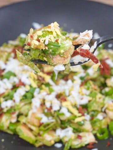 Brussels sprouts salad recipe: A refreshing salad featuring thinly sliced Brussels sprouts tossed with a tangy vinaigrette, dried cranberries, and crunchy nuts, for a delightful blend of flavors and textures.