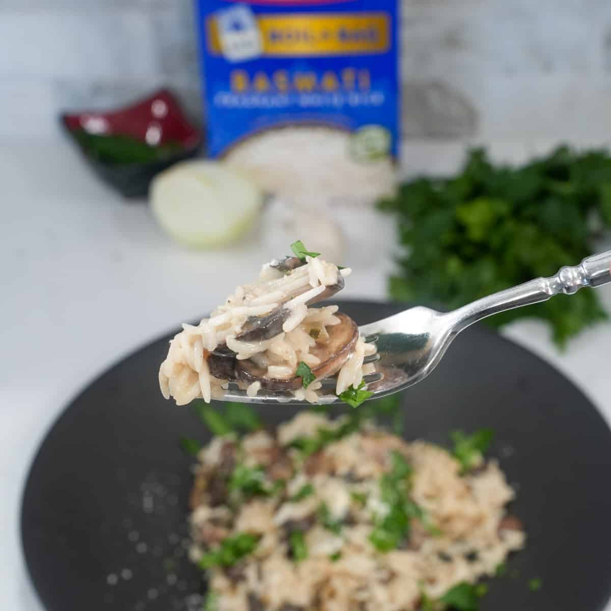 Close-up of creamy mushroom risotto in a white bowl garnished with parsley, showcasing its rich texture and earthy flavors.