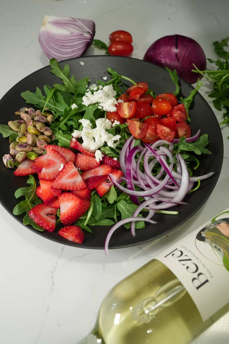 This Strawberry Arugula Goat Cheese Salad, featuring peppery arugula, sweet strawberries, creamy goat cheese, and toasted pistachios. 